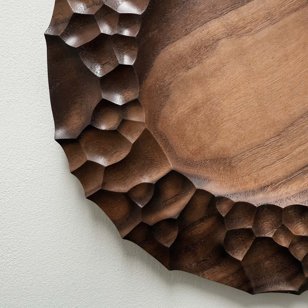 Biome plate and round palm bowl in tanned walnut on a light background