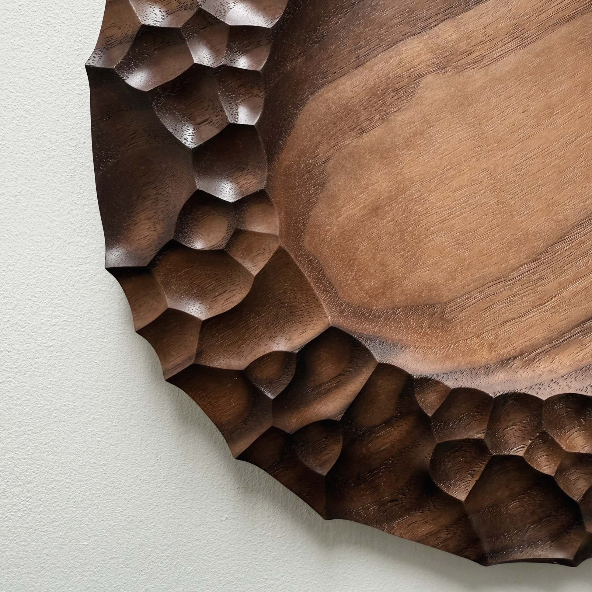 Biome plate and round palm bowl in tanned walnut on a light background