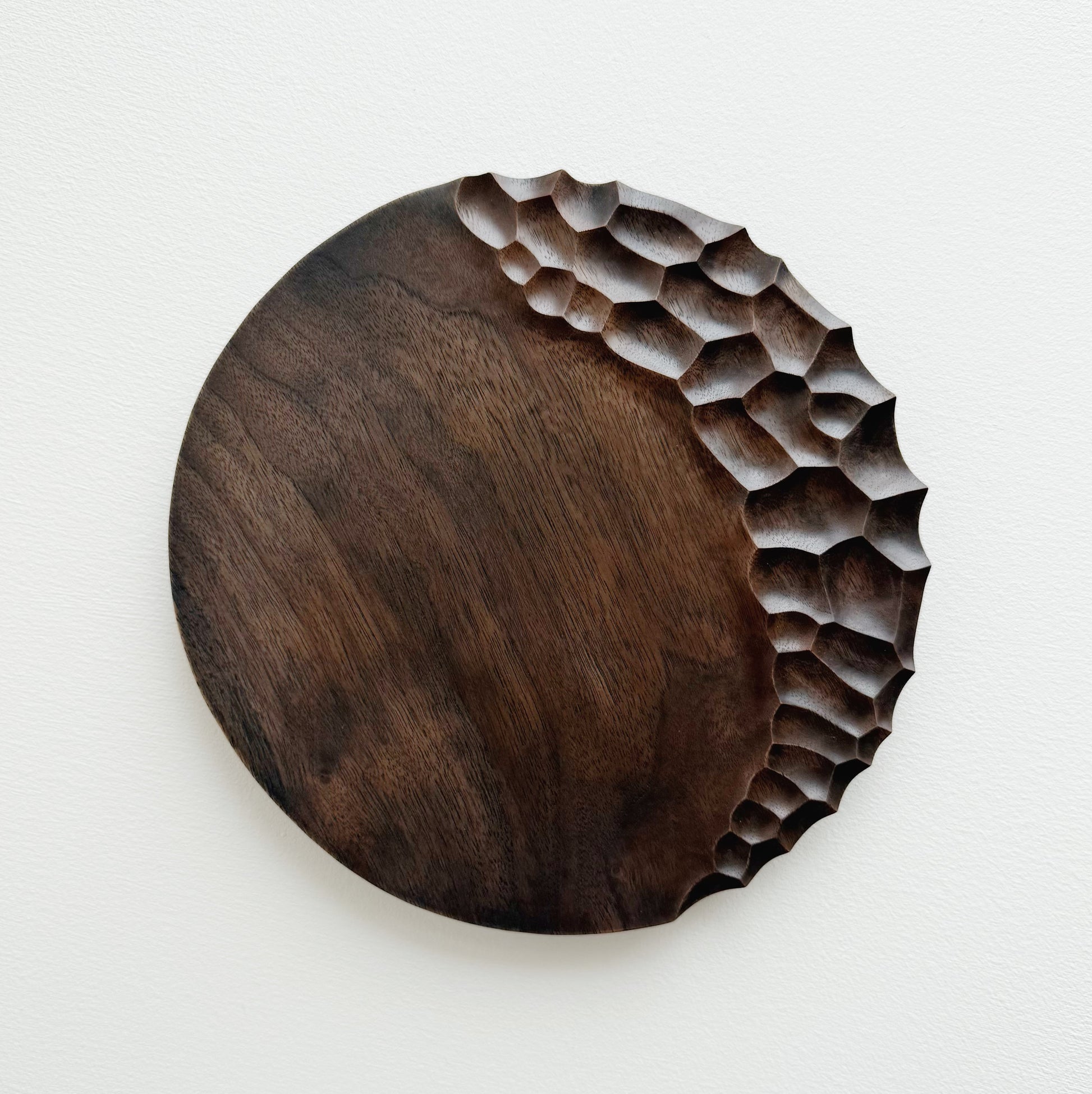 Black walnut coast plate with cratered edge on white background