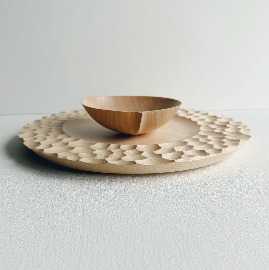 Sycamore bowl and plate set with sculptural design on a white background