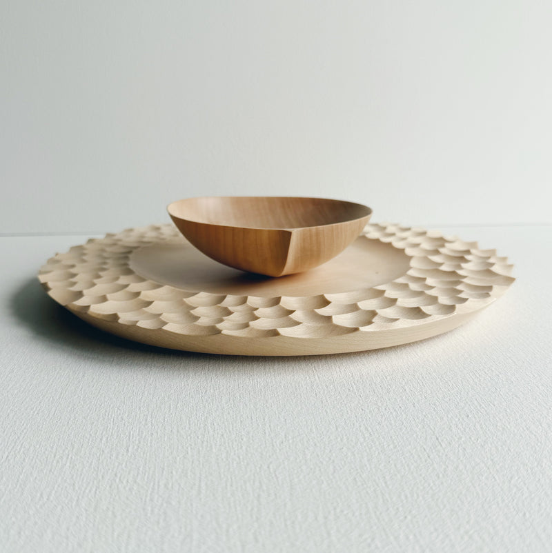 Sycamore bowl and plate set with sculptural design on a white background