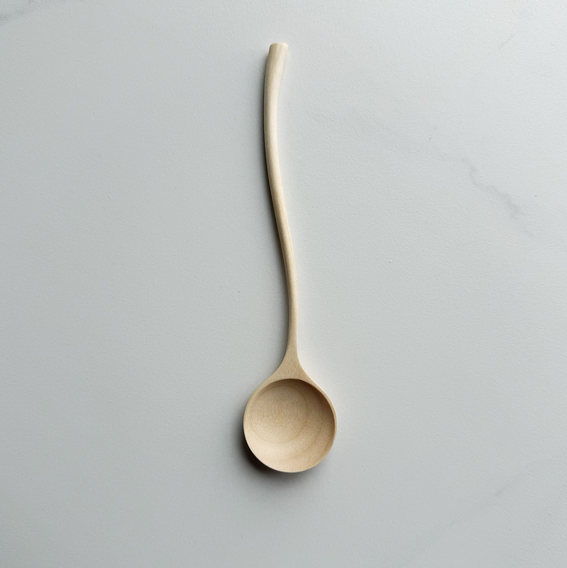 Sycamore curvy spoon on a light background