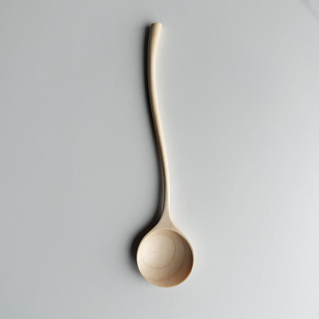 Sycamore curvy spoon on a light background