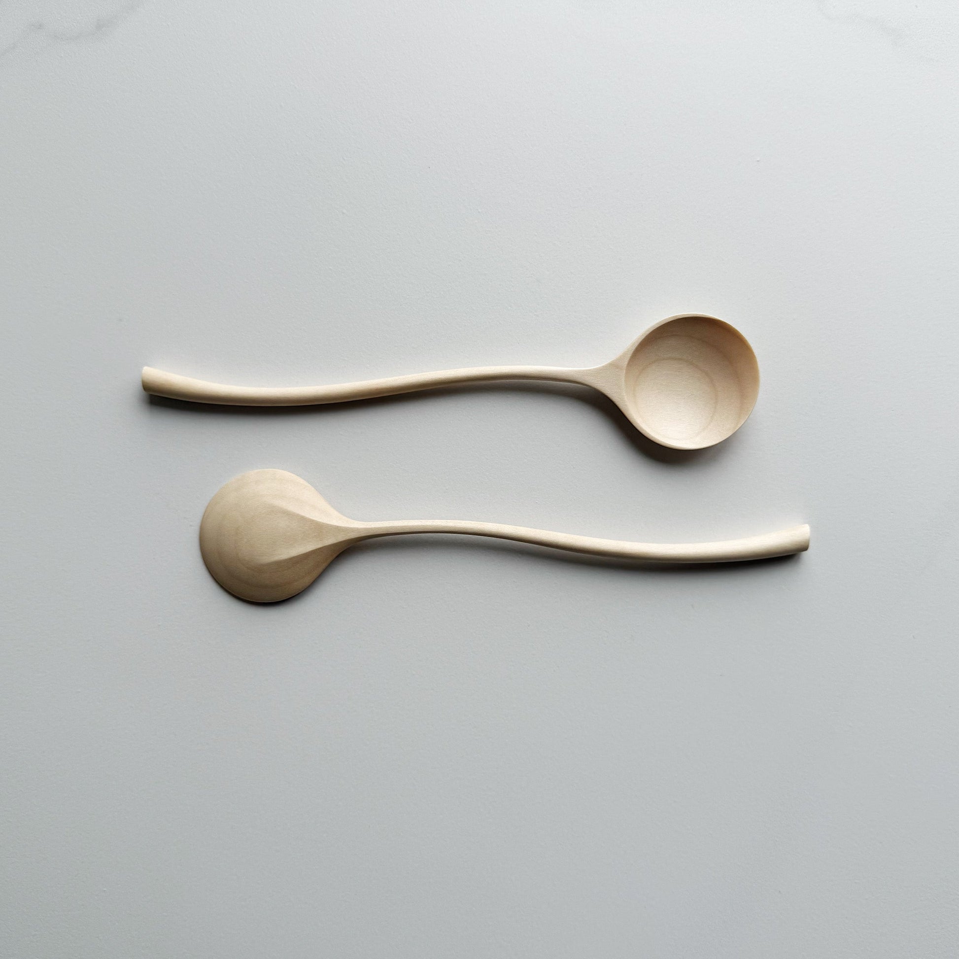 Sycamore curvy spoon on a light background