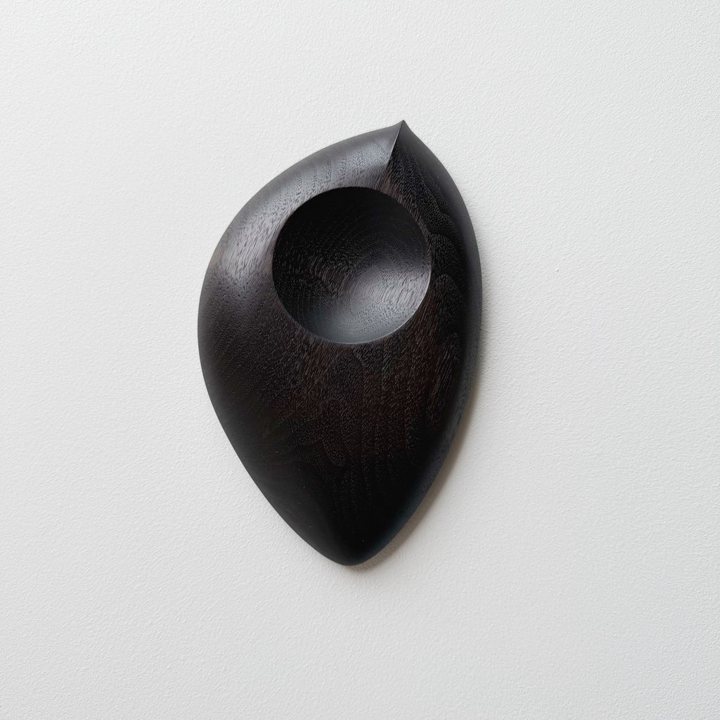 Droplet dish in ebonised walnut on a light background
