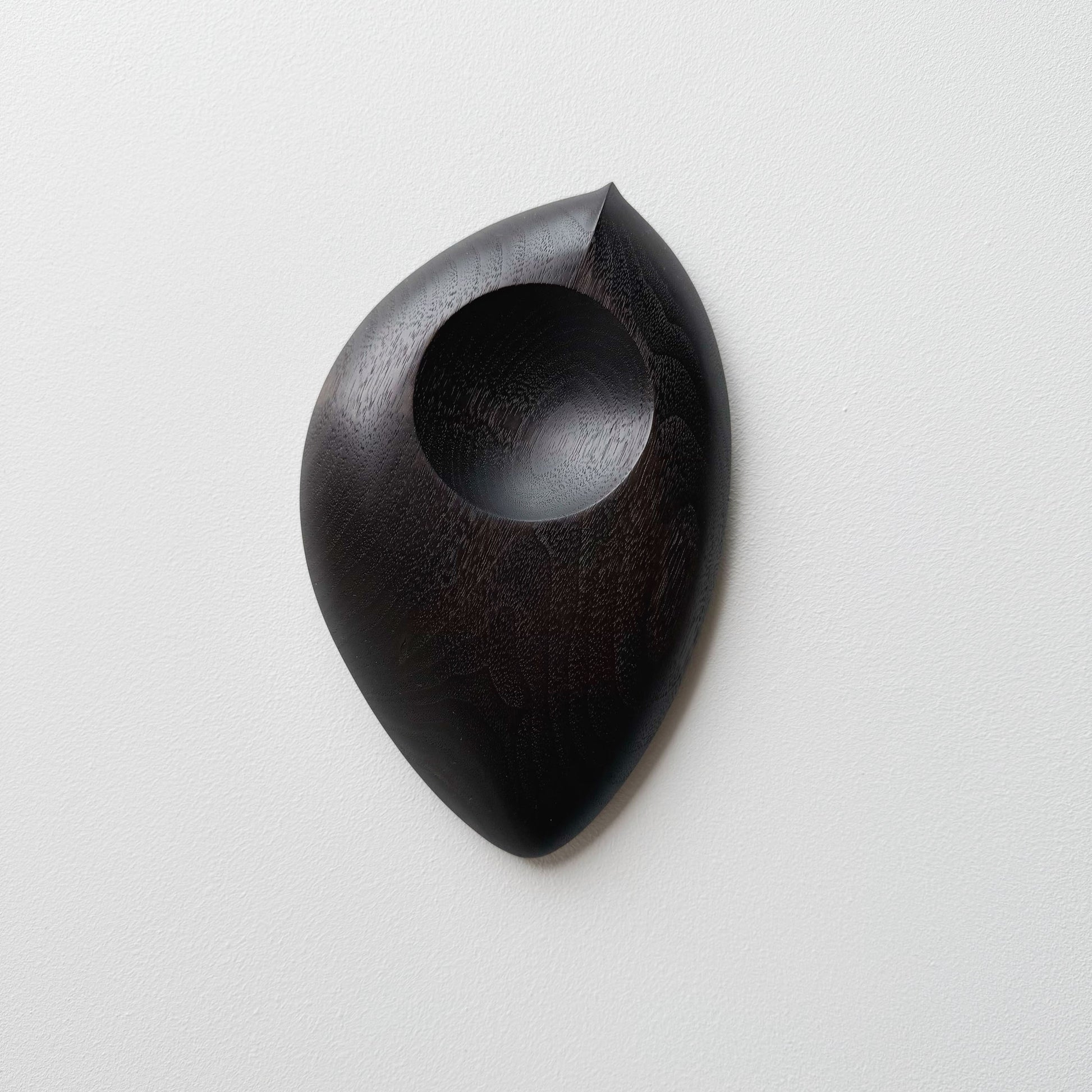 Droplet dish in ebonised walnut on a light background

