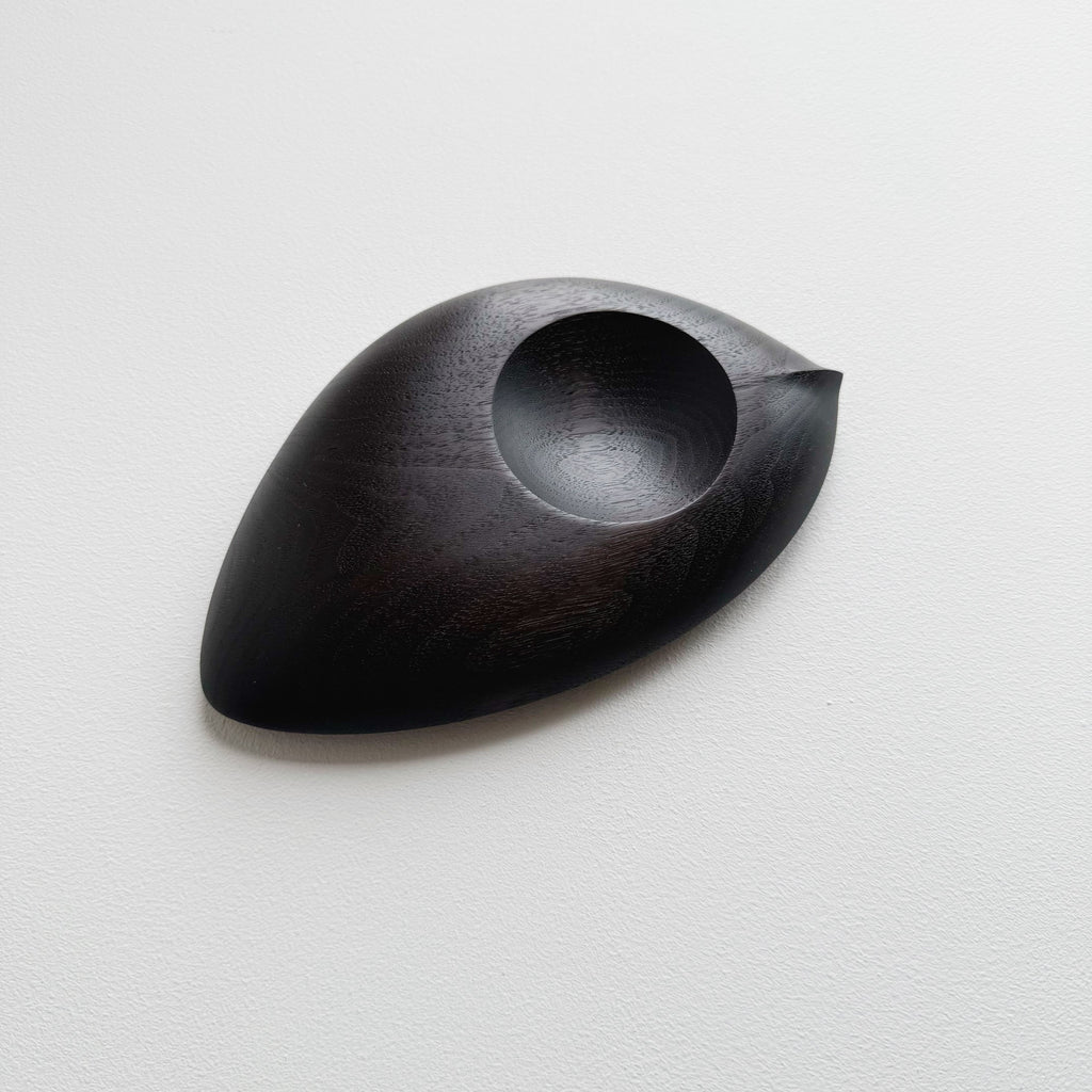 Droplet dish in ebonised walnut on a light background
