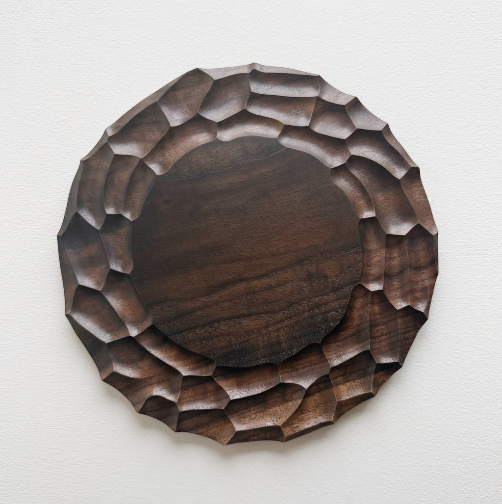 Wooden walnut plate on a white background