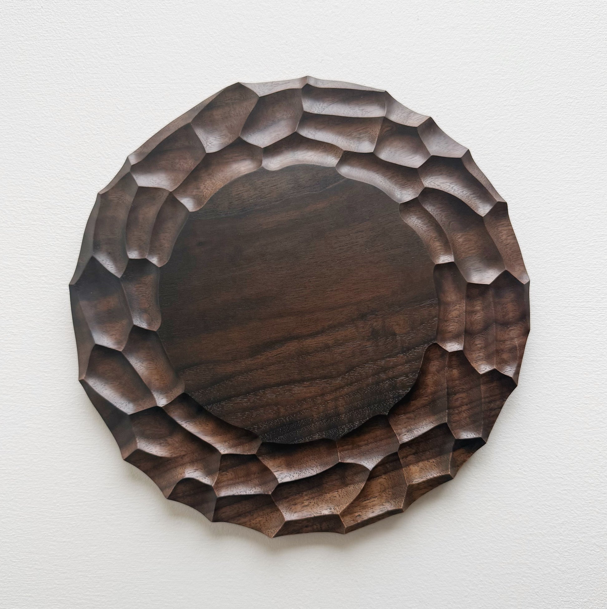 Wooden walnut plate on a white background