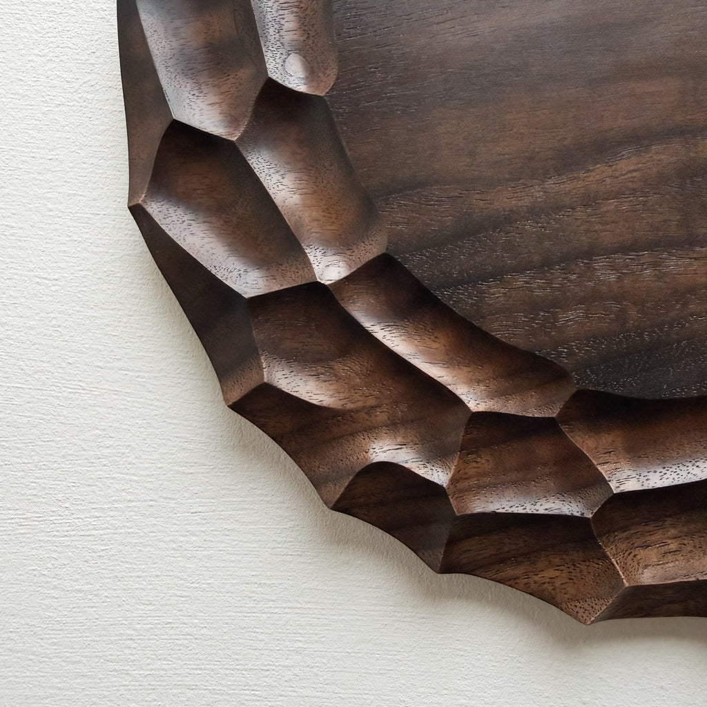 Close up of wooden walnut plate on a white background