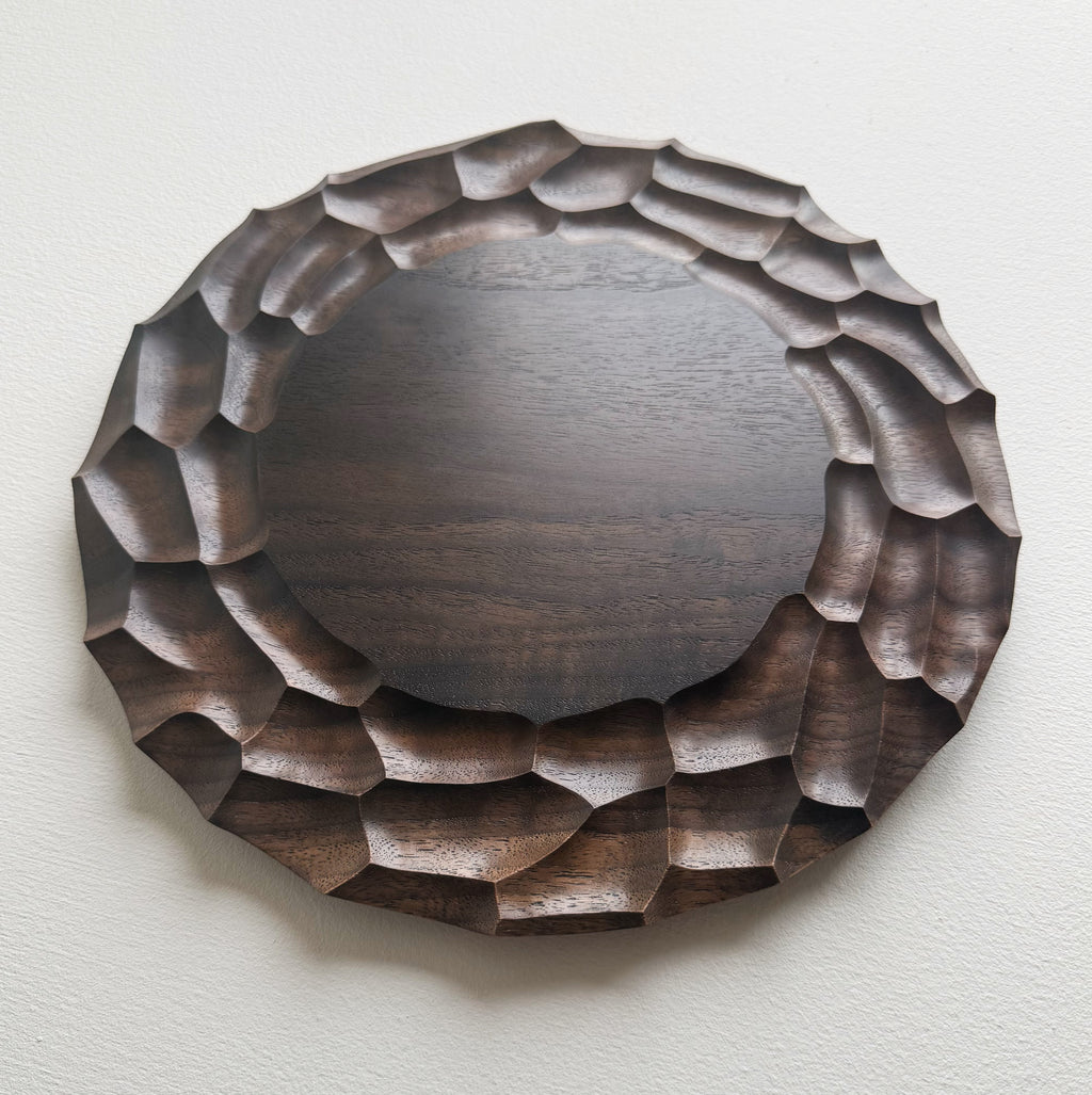 Wooden walnut plate on a white background