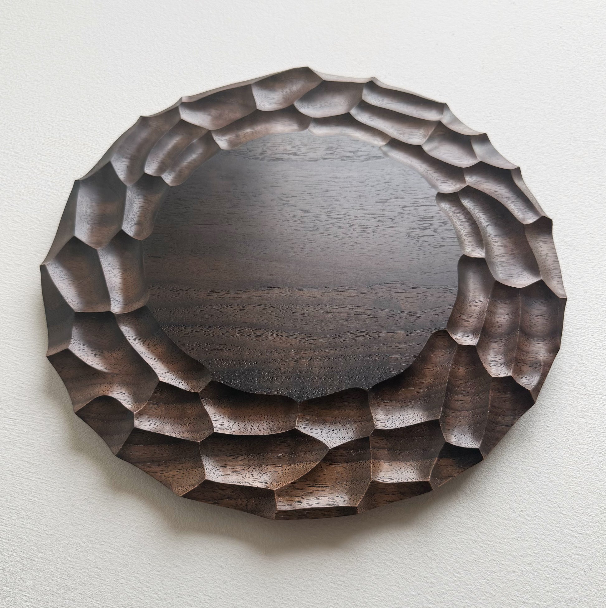 Wooden walnut plate on a white background