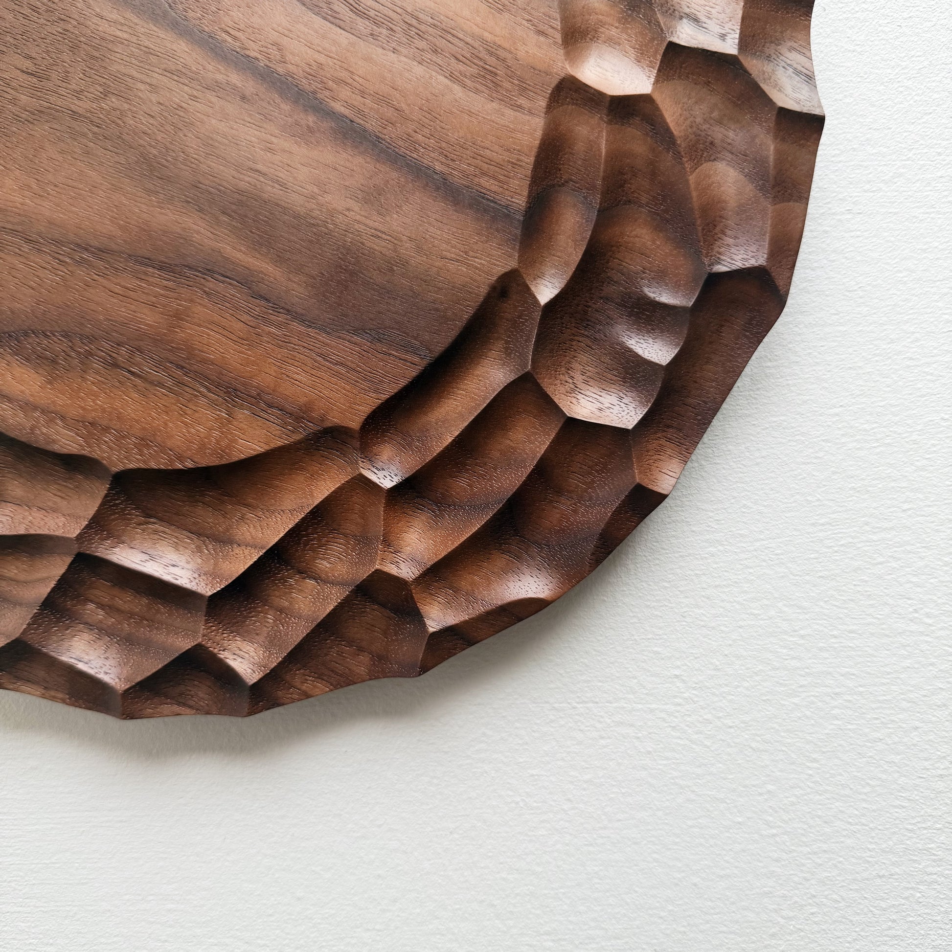 Close up of walnut Dunes plate on a white background
