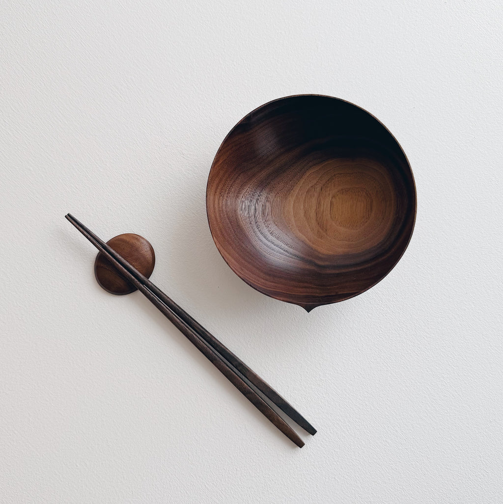 Walnut eating set with bowl and chopsticks on a white background 