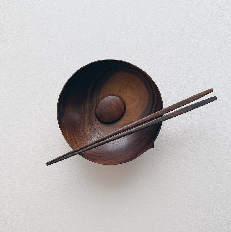 Walnut eating set with bowl and chopsticks on a white background 