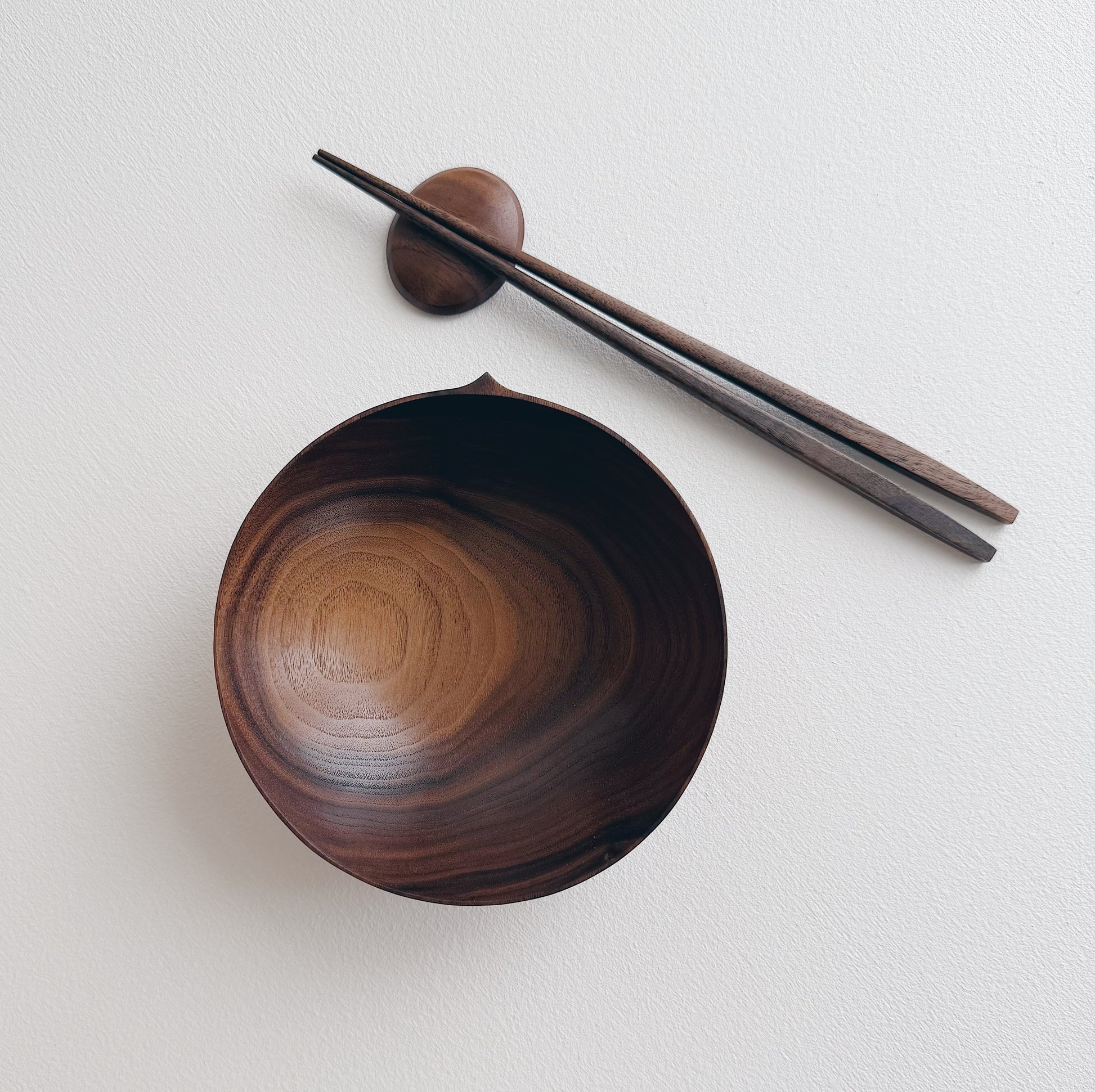 Walnut eating set with bowl and chopsticks on a white background 