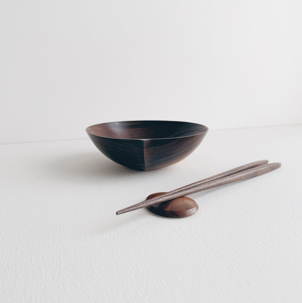 Walnut eating set with bowl and chopsticks on a white background 