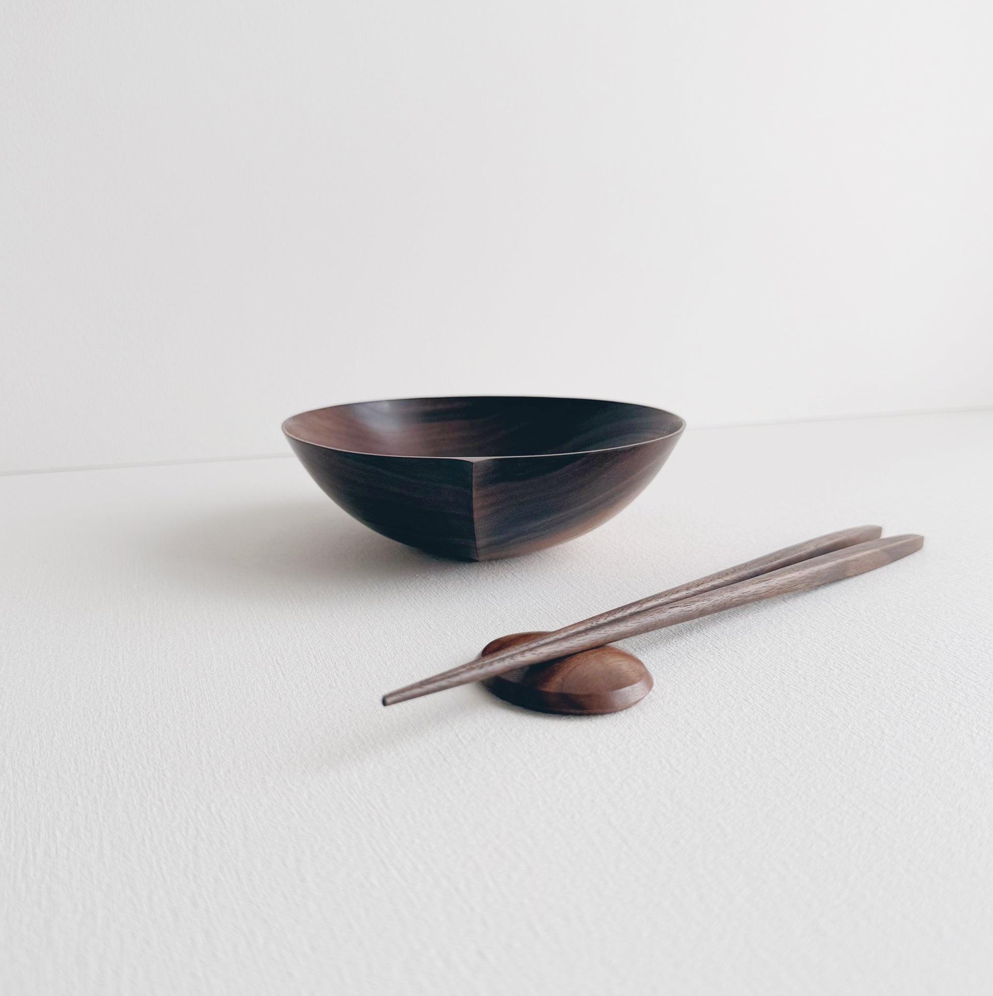 Walnut eating set with bowl and chopsticks on a white background 