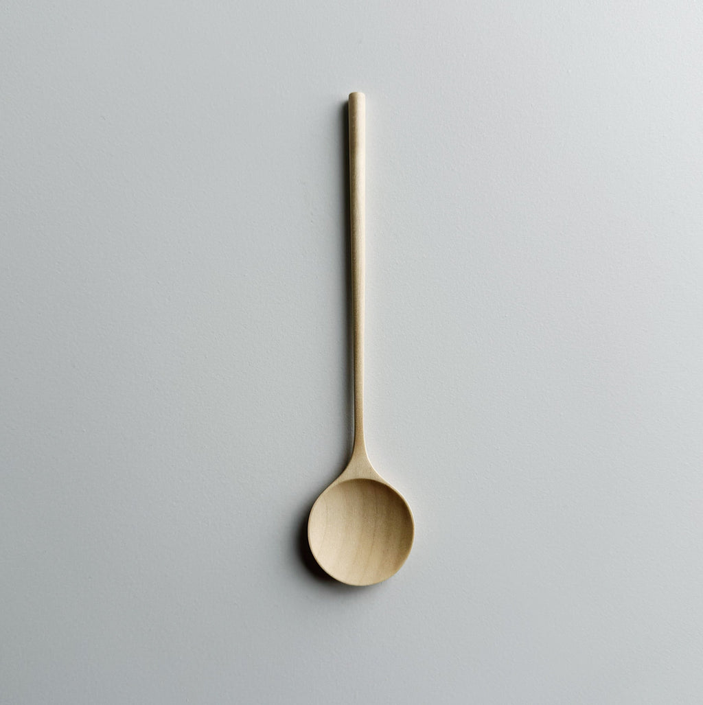Sycamore eating spoon on light background