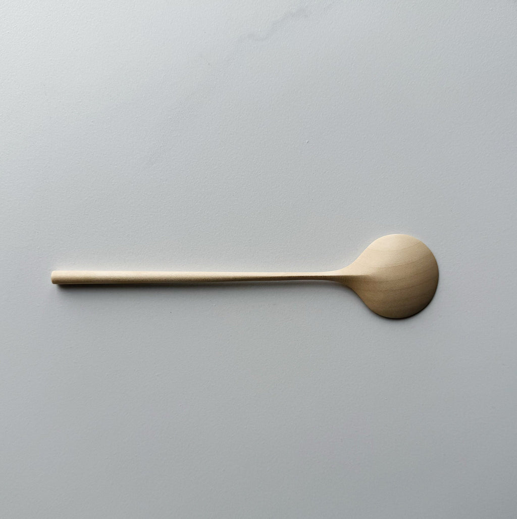 Sycamore eating spoon on light background