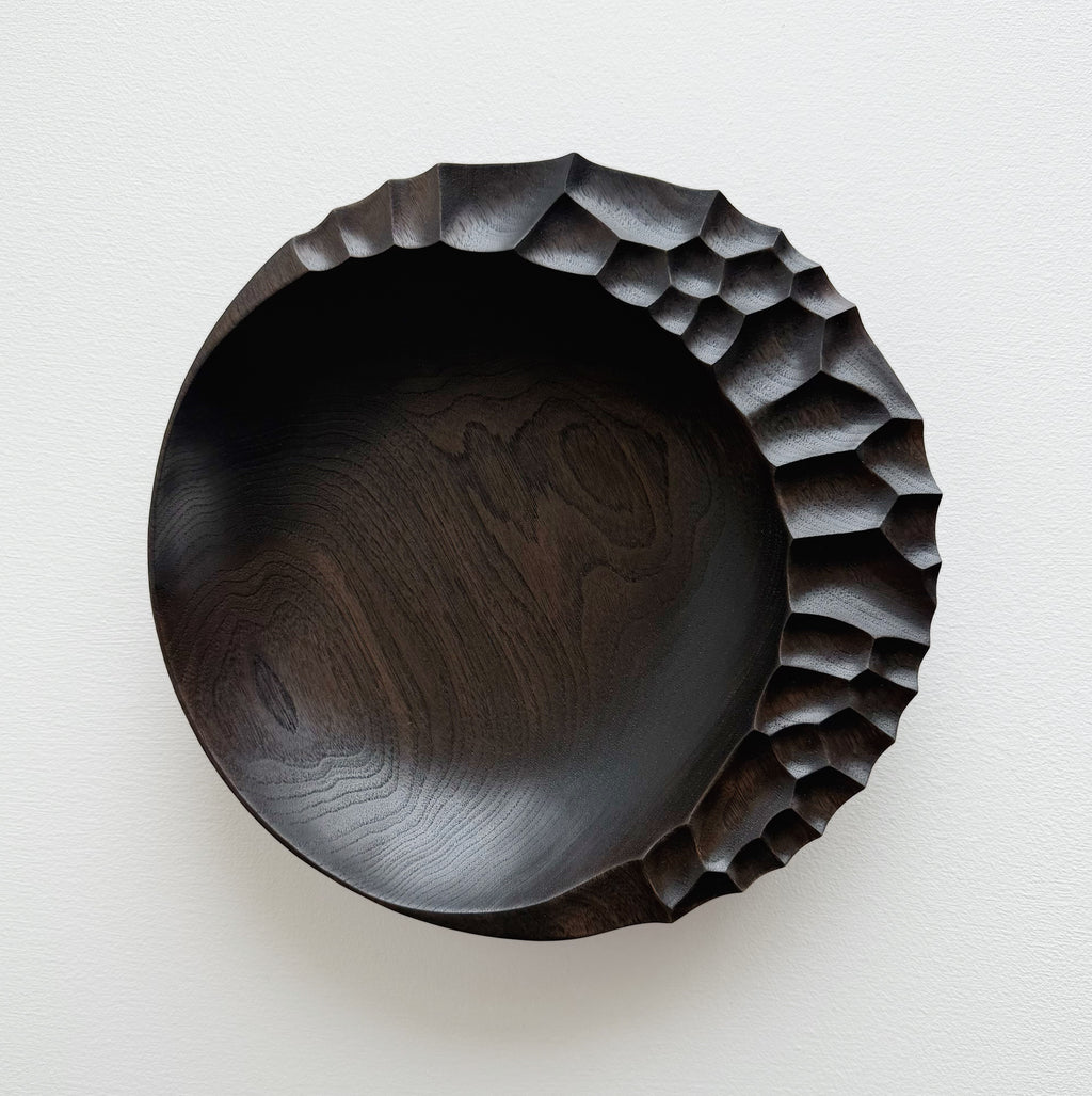 Ebonised walnut presentation board with sculptural design on a white background