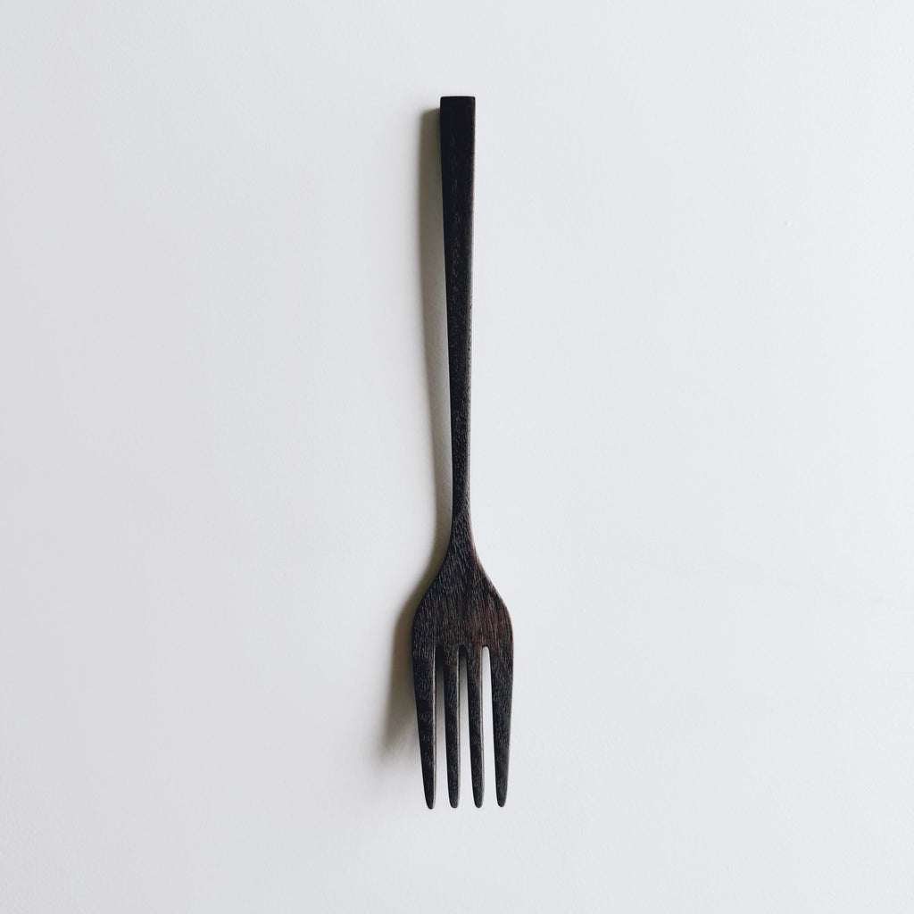 Black walnut fork on a white background