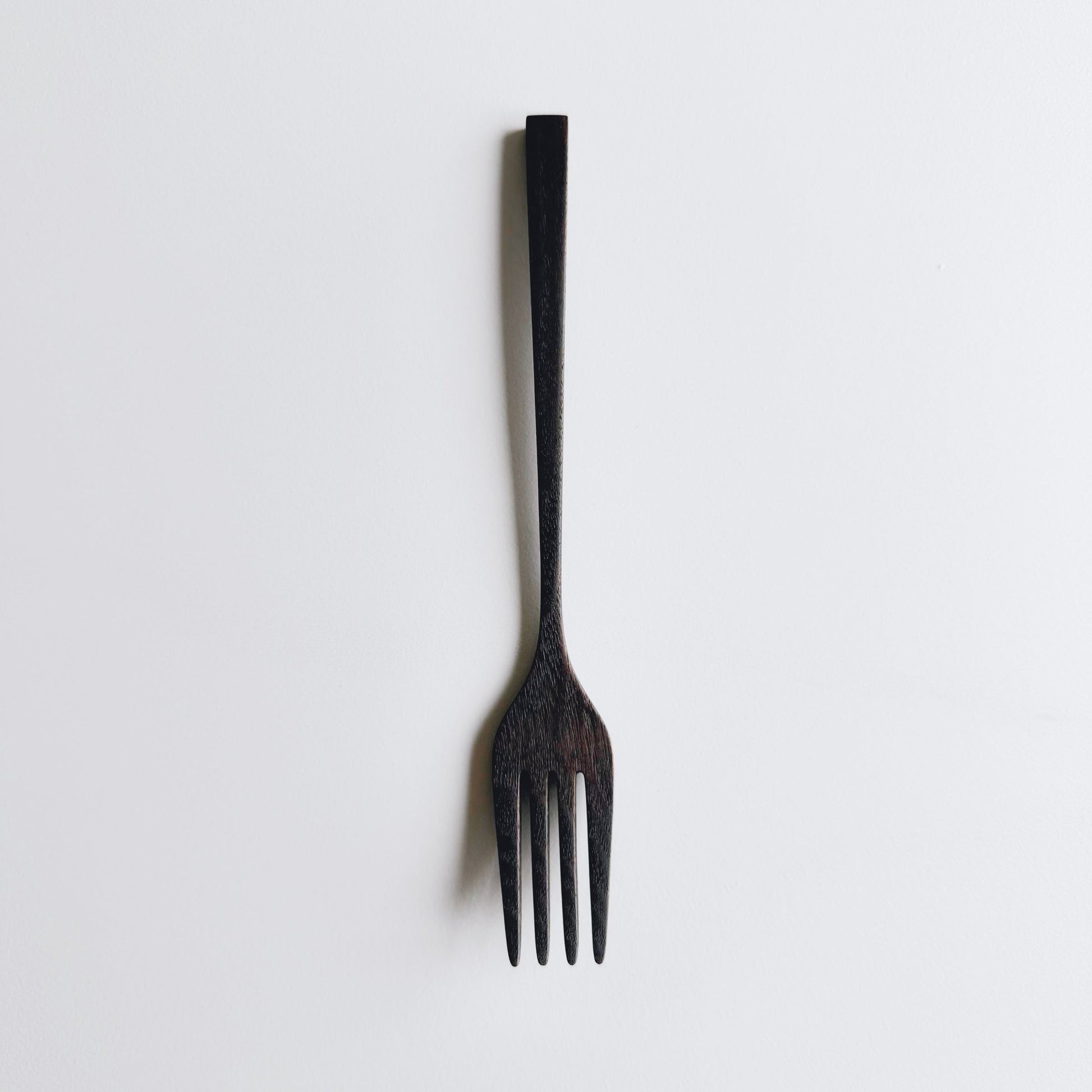 Black walnut fork on a white background