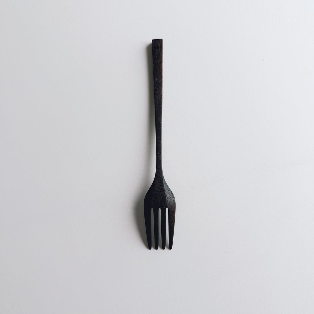 Black walnut fork on a white background