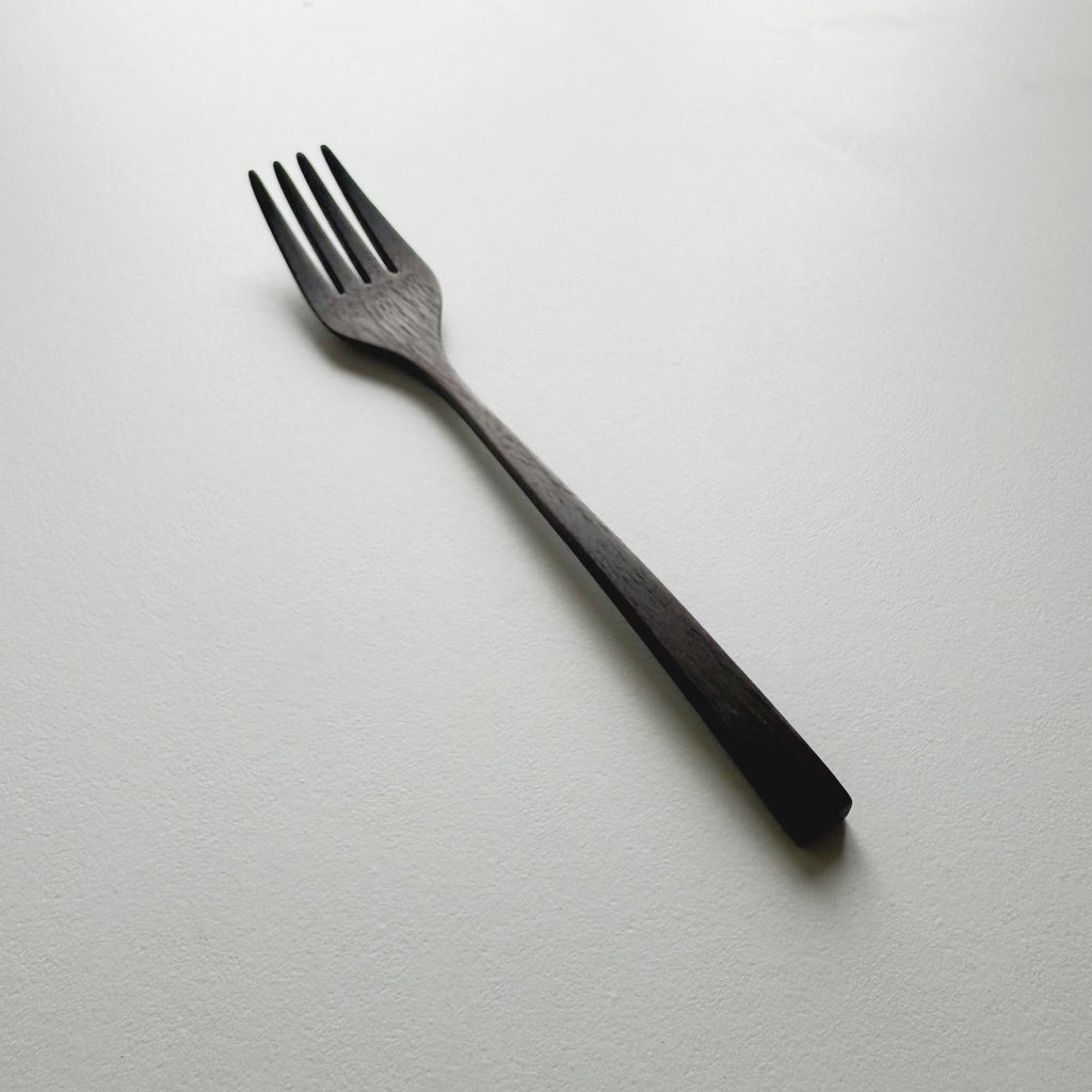 Black walnut fork on a white background
