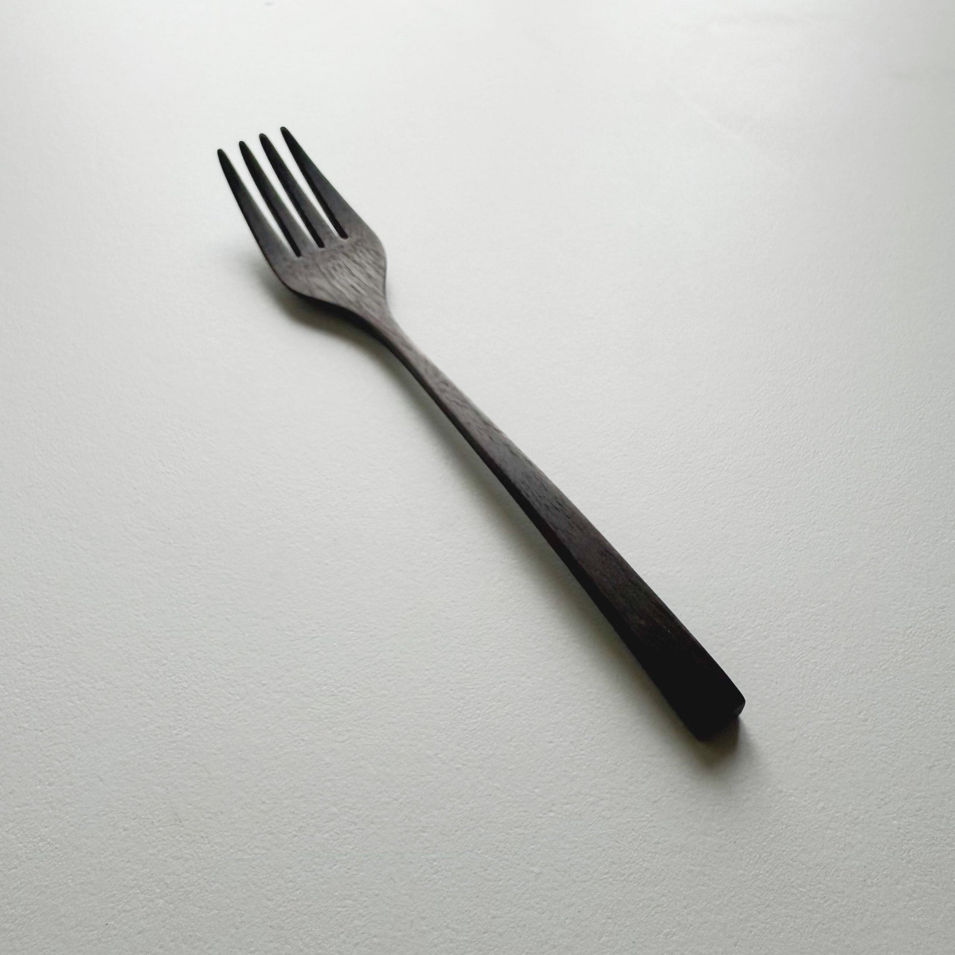 Black walnut fork on a white background
