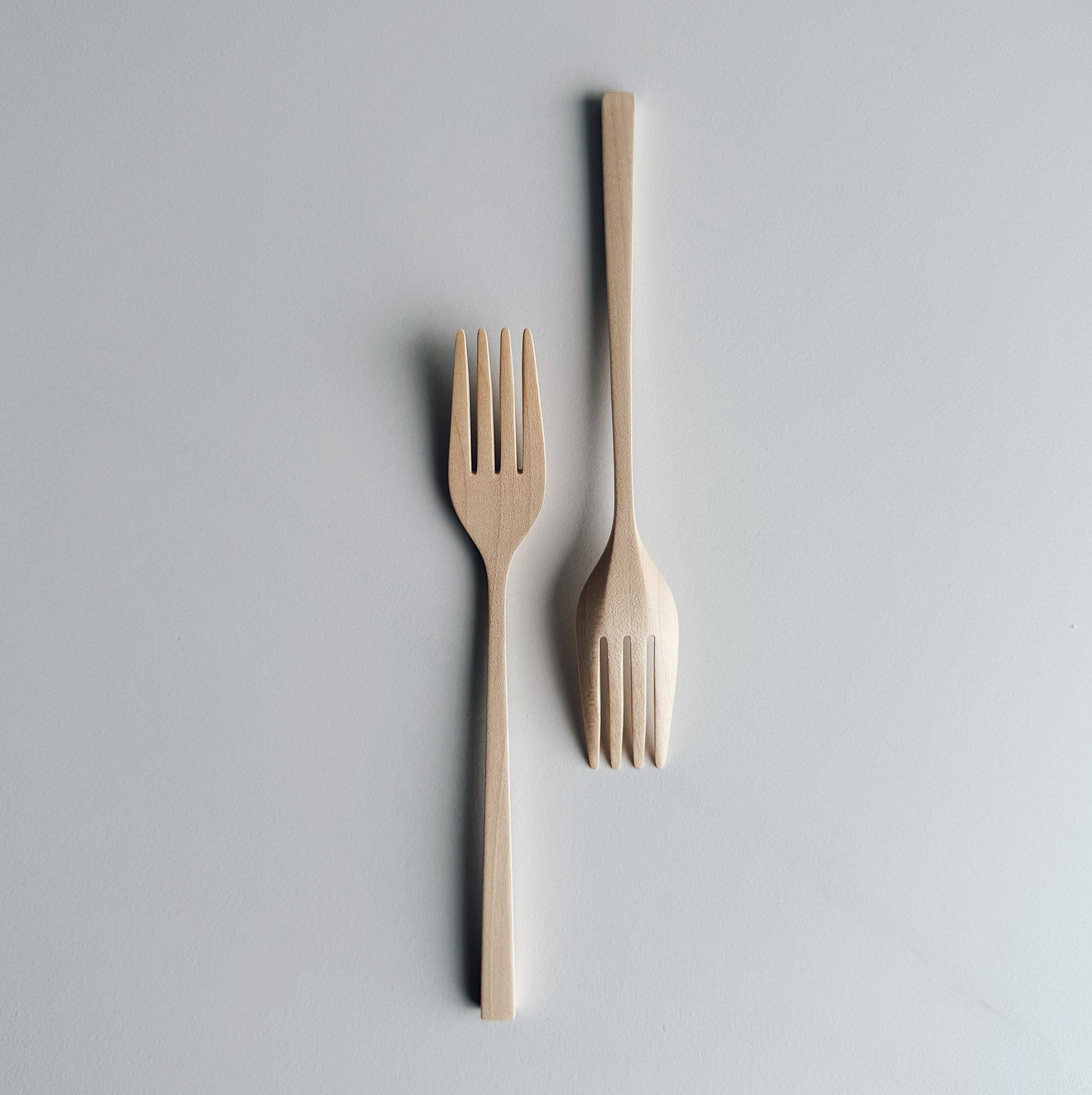 Pair of Sycamore forks on light background