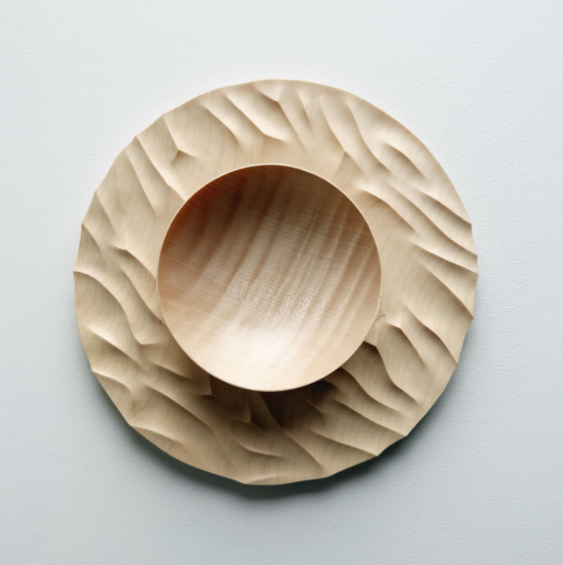 Large Gathered sycamore wooden plate with textured edge and bowl on a light background