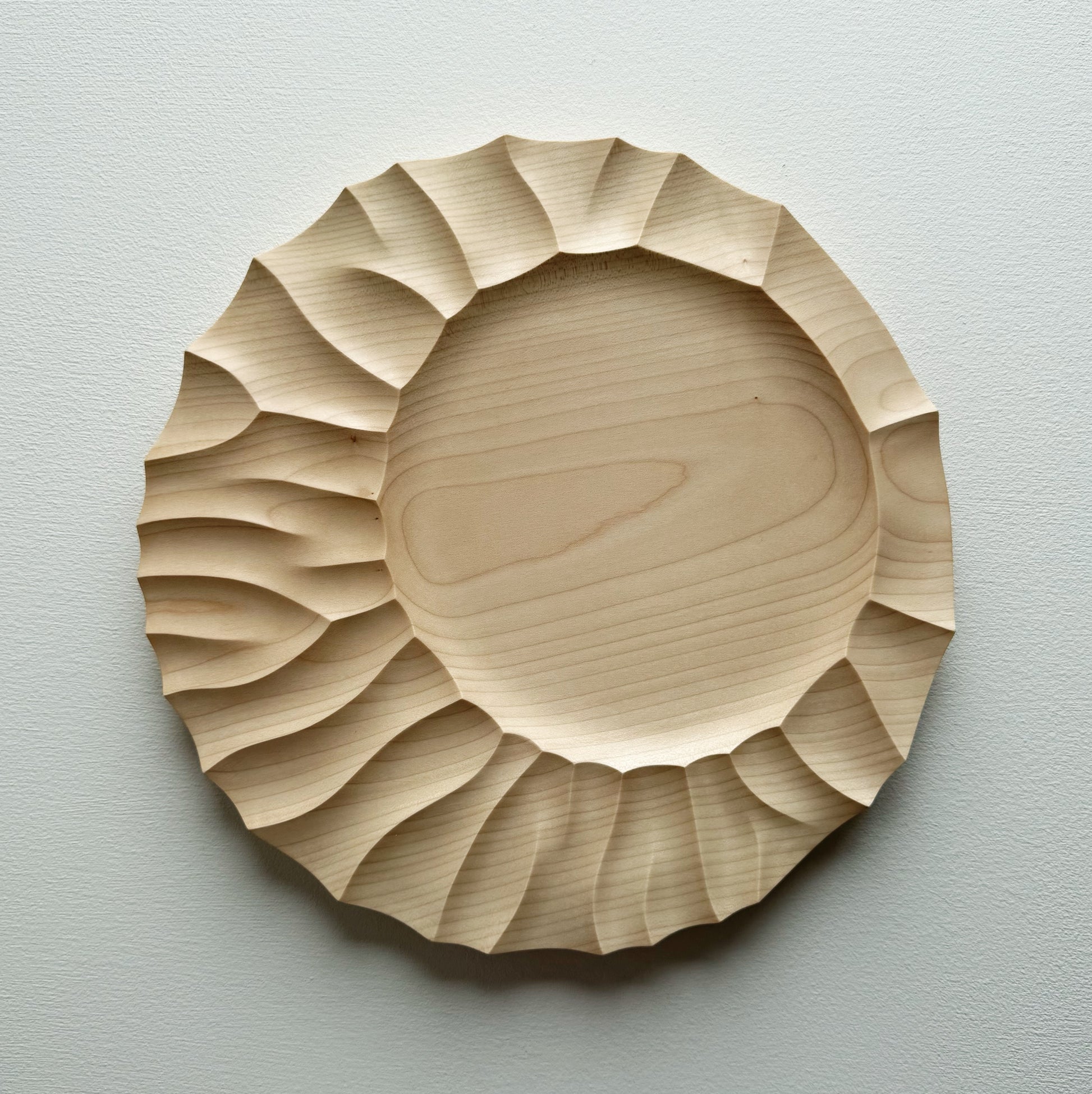Sycamore wood plate on a white background