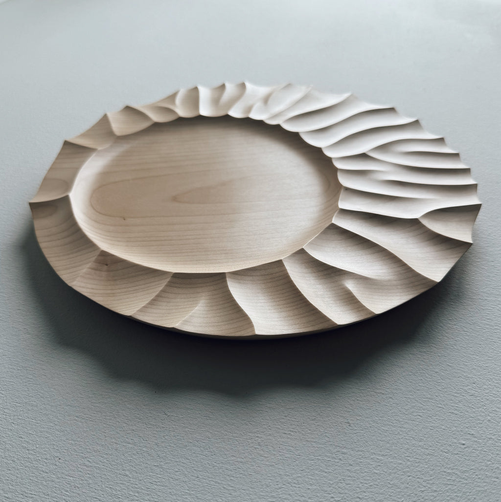 Sycamore wood plate on a white background