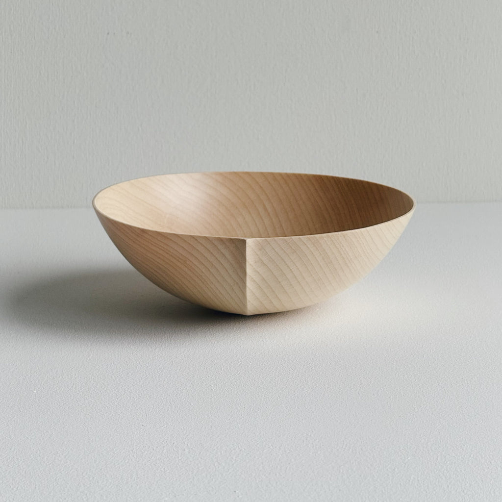 Round palm bowl in sycamore on a white background
