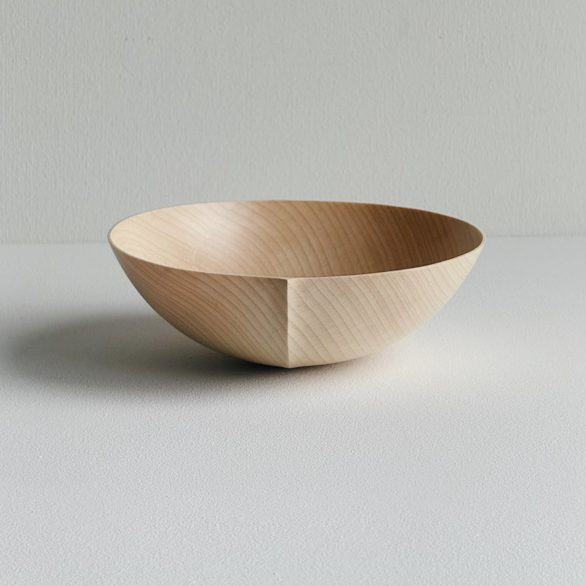 Round palm bowl in sycamore on a white background
