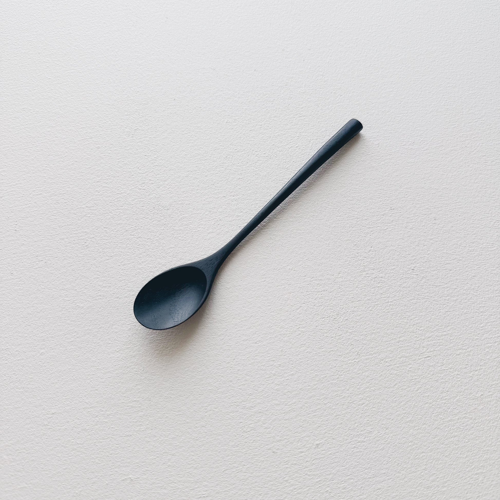 Oval eating spoon in ebonised walnut