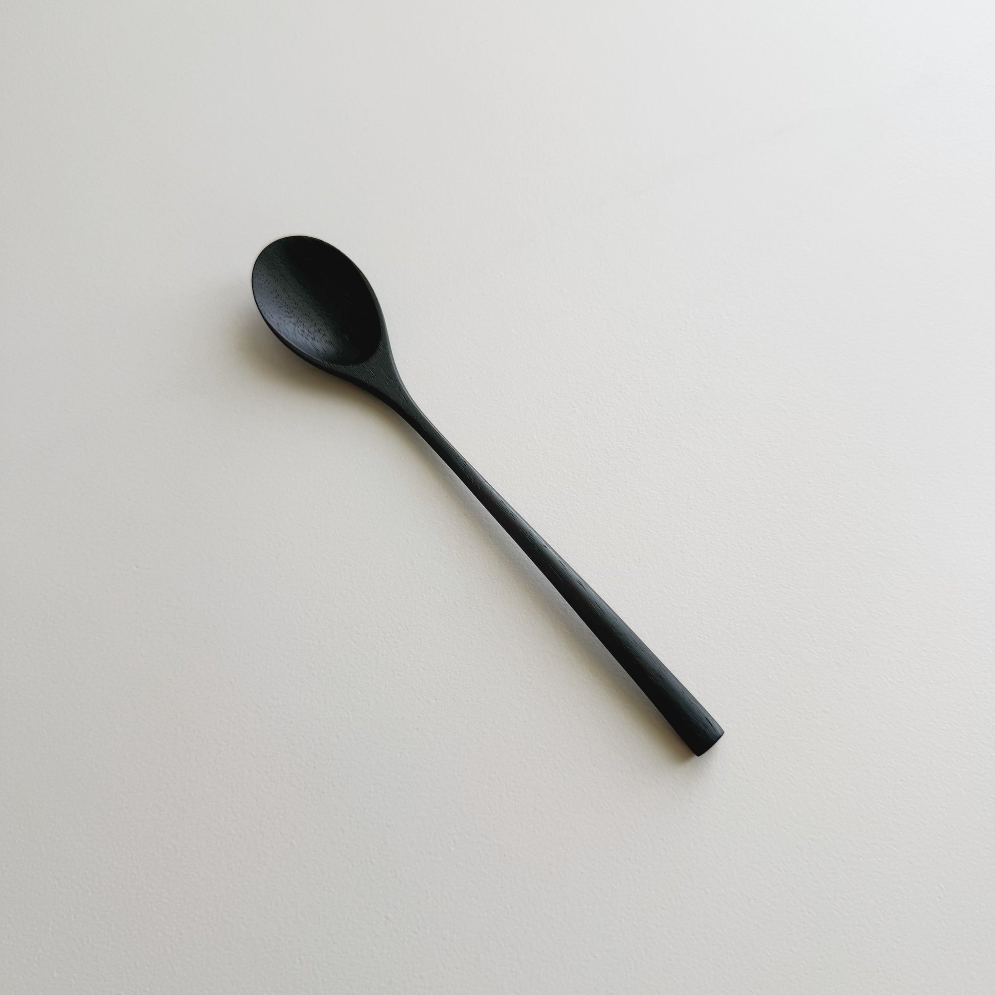 Oval eating spoon in ebonised walnut