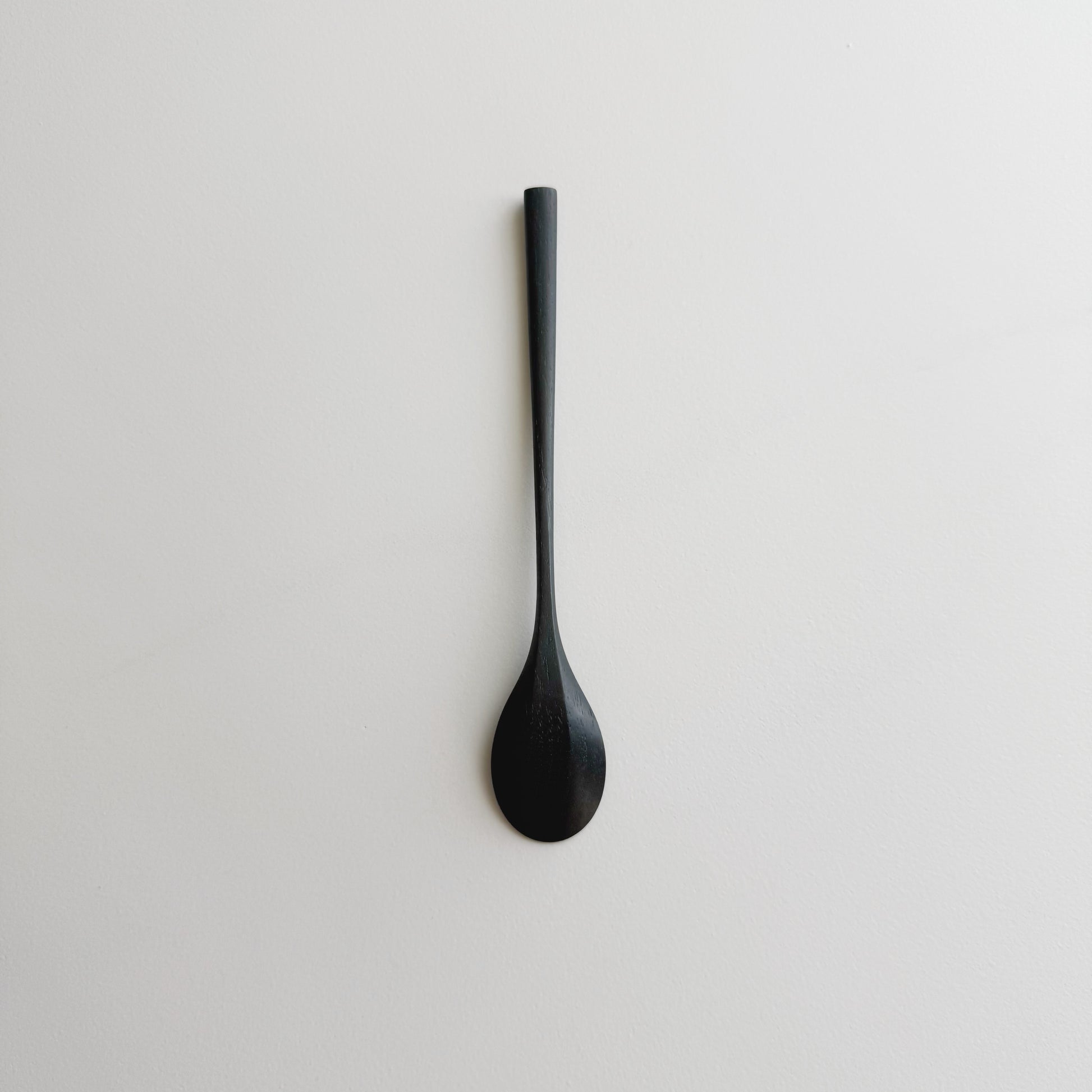 Oval eating spoon in ebonised walnut