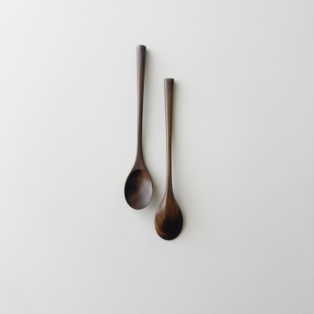 Pair of small oval eating spoons in walnut