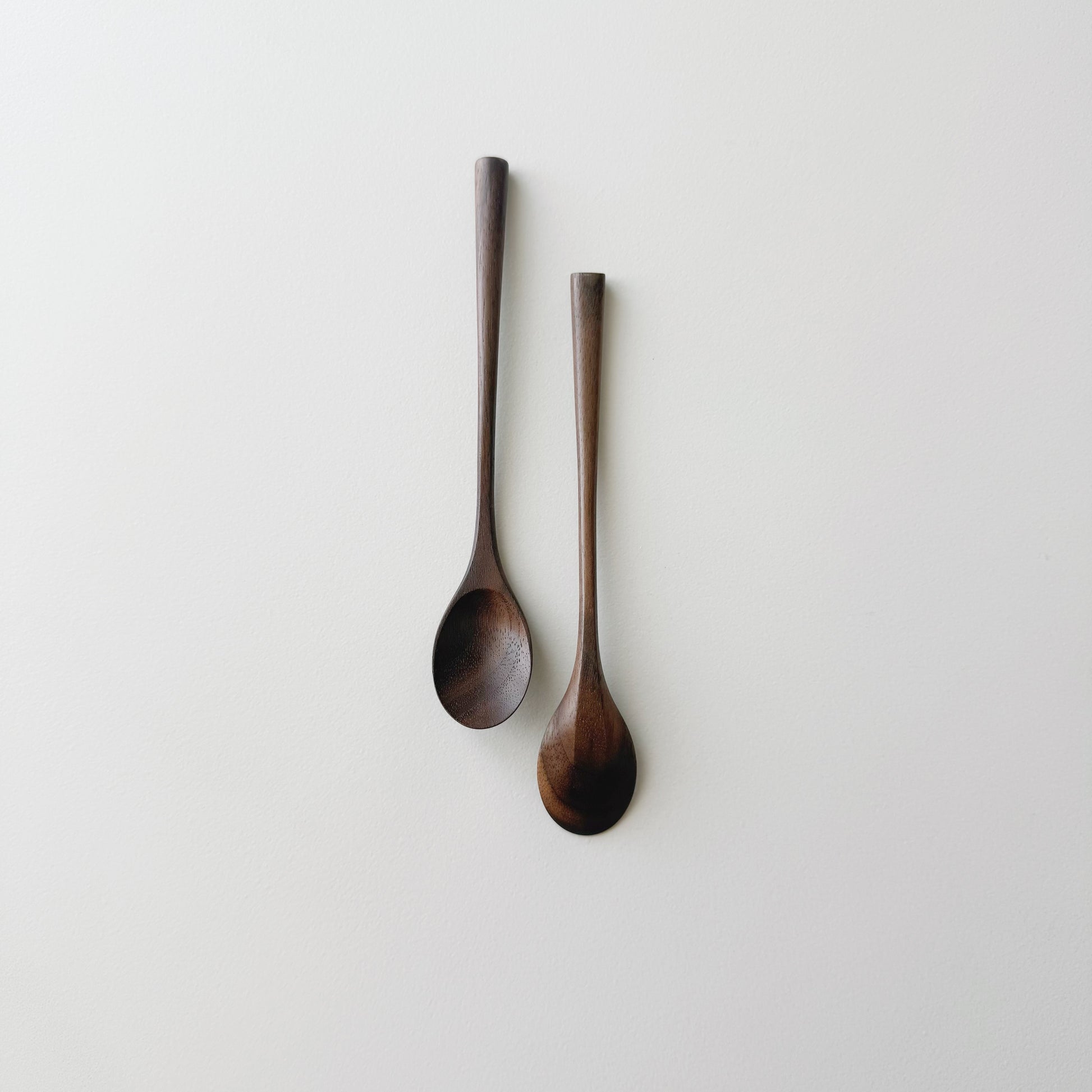Pair of small oval eating spoons in walnut