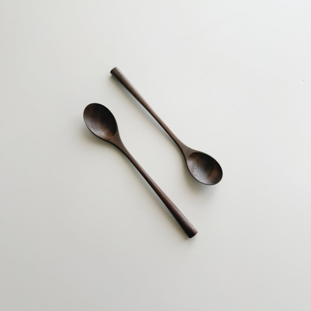 Pair of small oval eating spoons in walnut