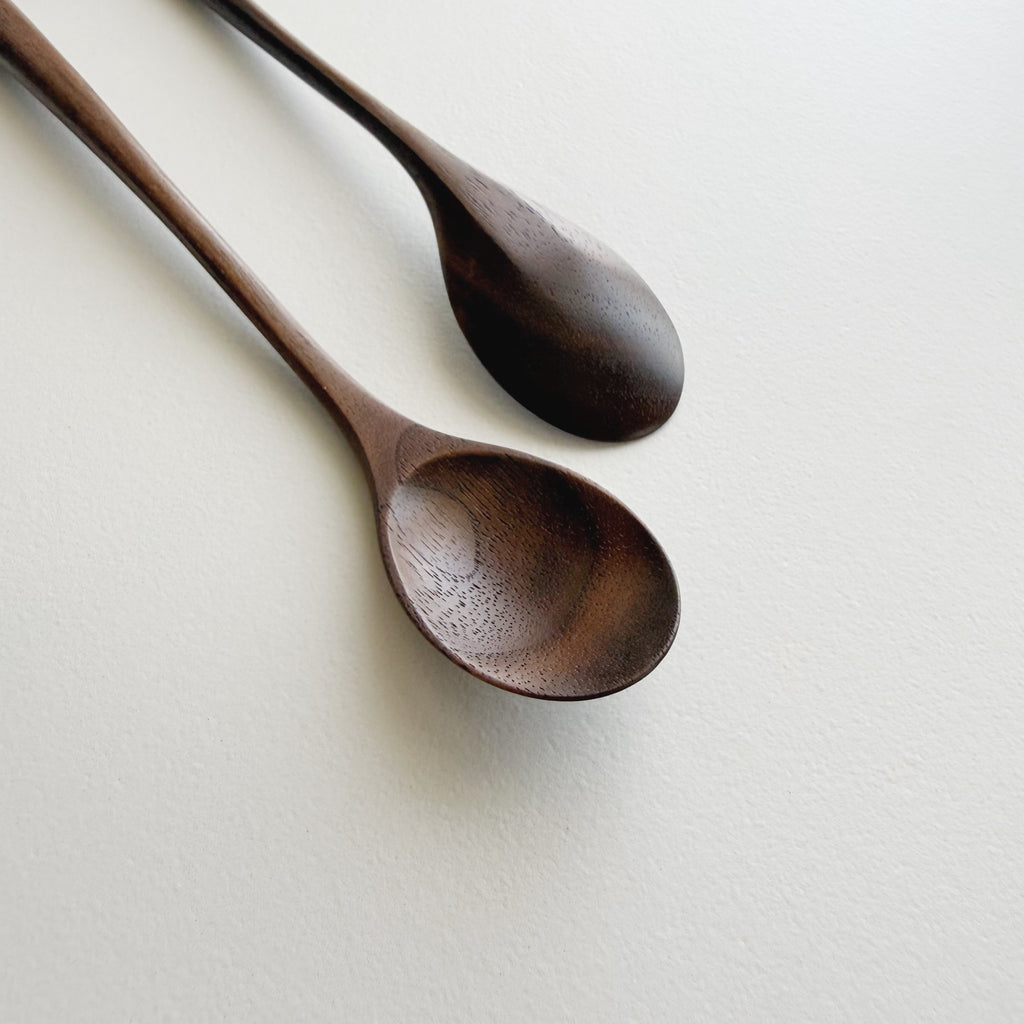 Pair of small oval eating spoons in walnut