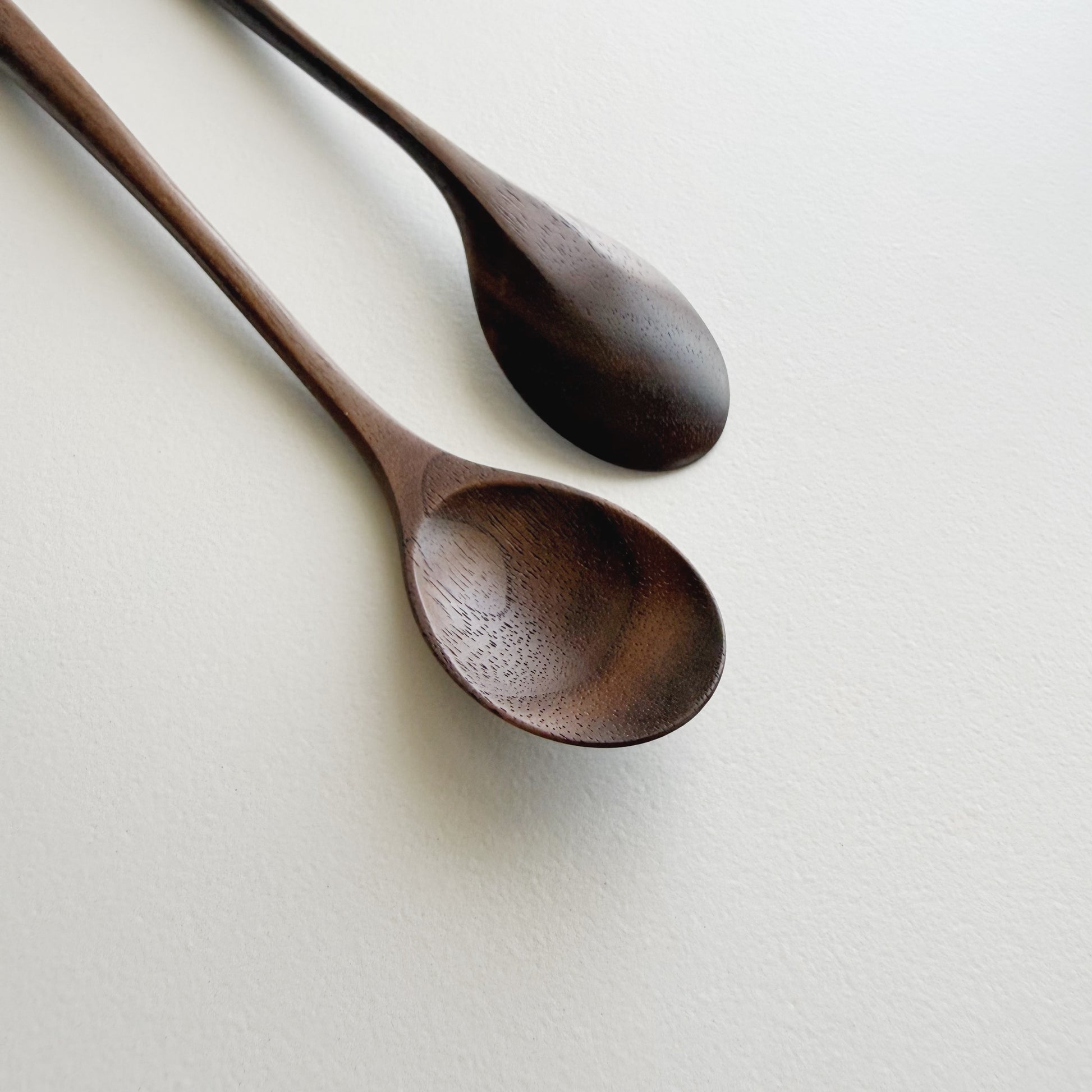 Pair of small oval eating spoons in walnut