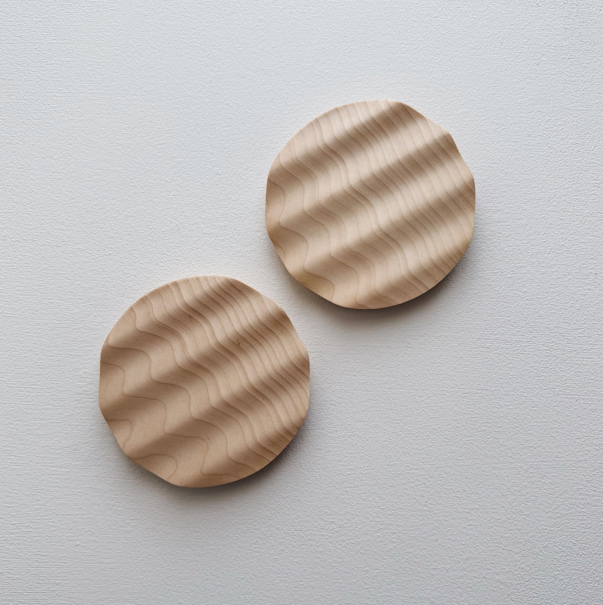 Pair of small wavy side plates in sycamore