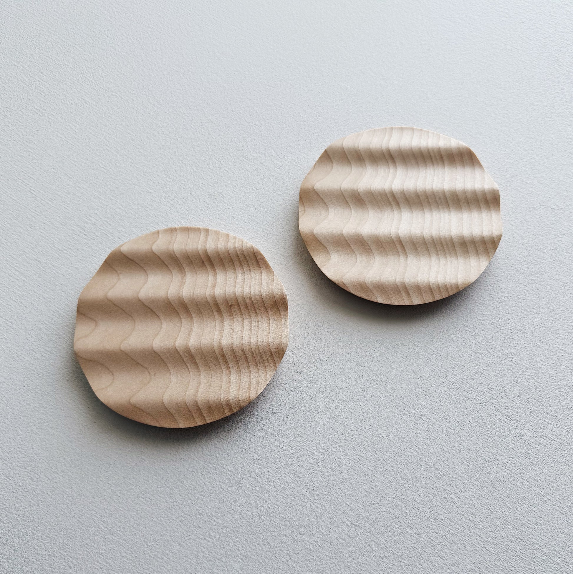 Pair of small wavy side plates in sycamore