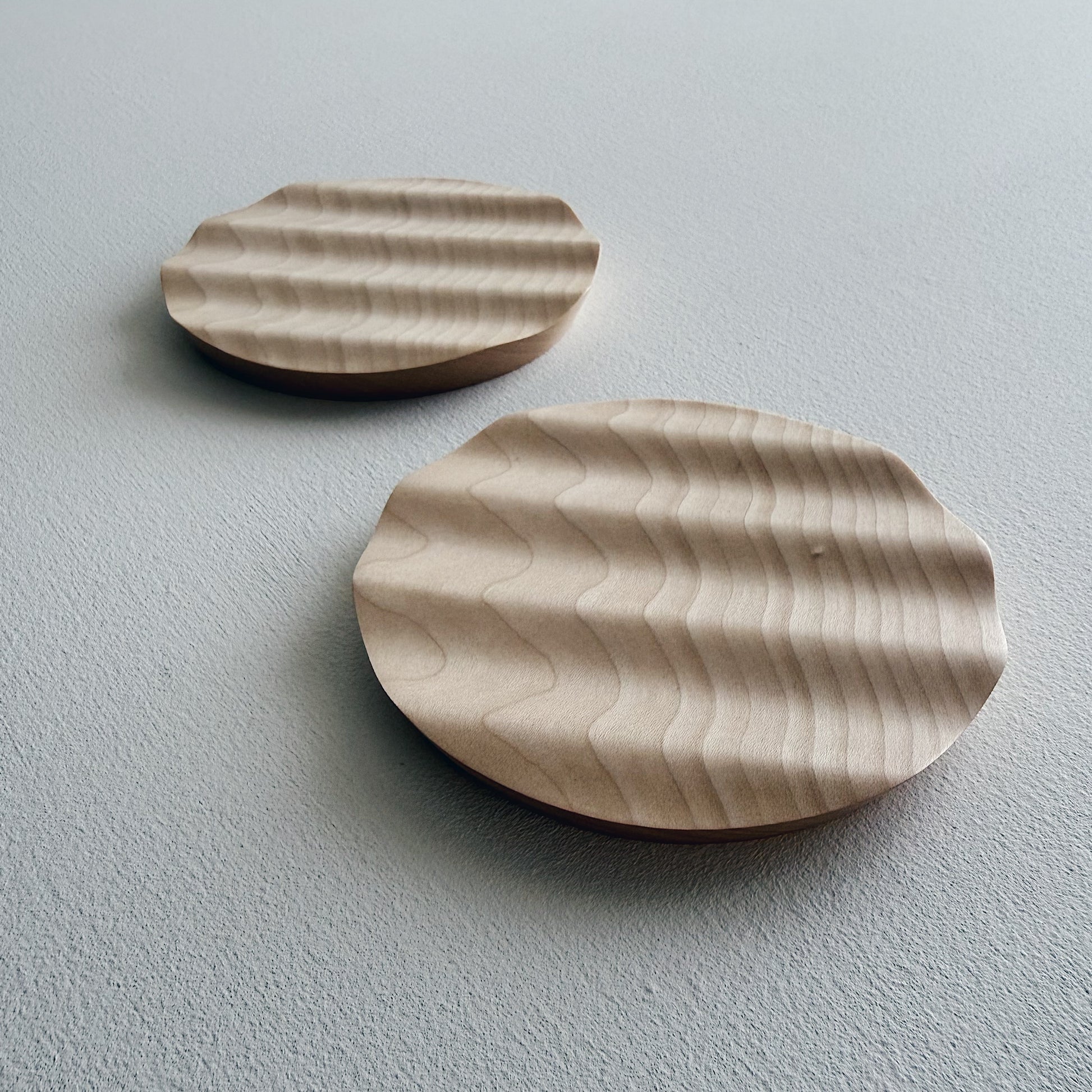 Pair of small wavy side plates in sycamore