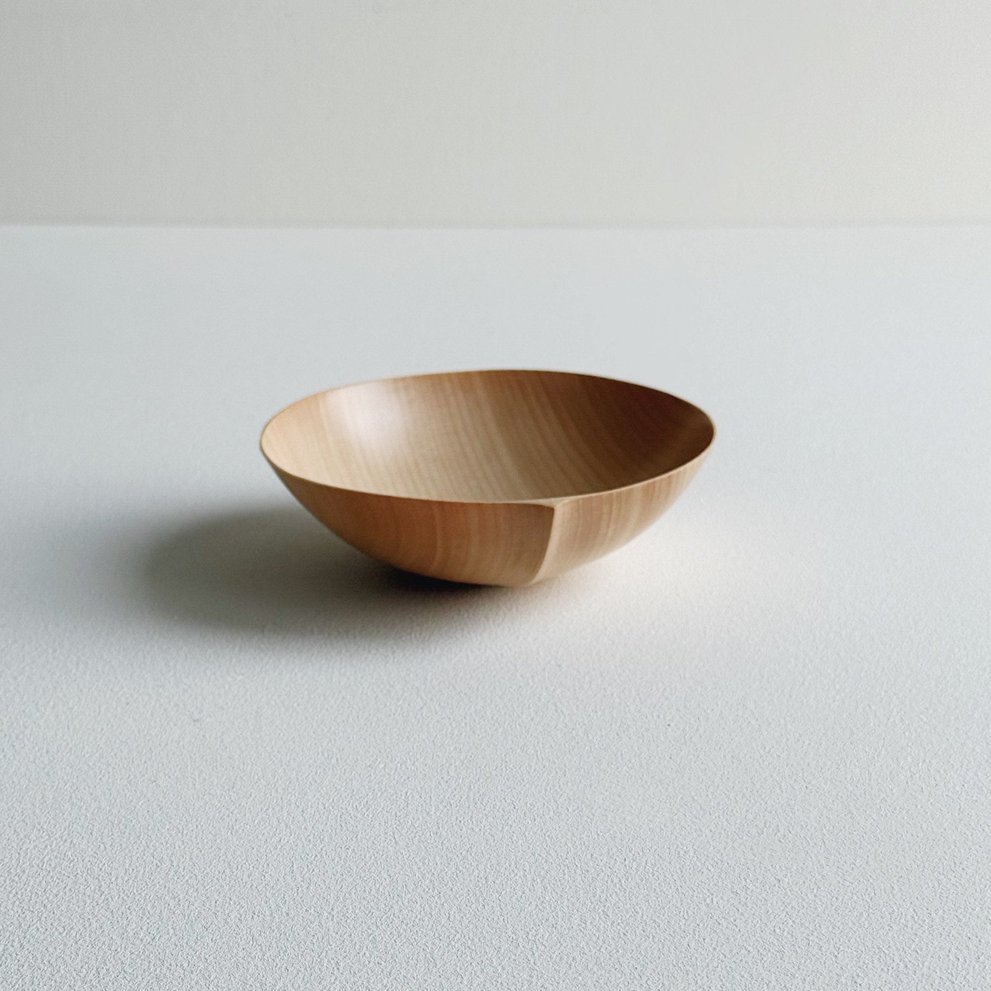 Sycamore wooden bowl on a light background