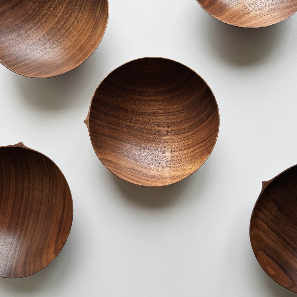 Wooden bowls in walnut on a white background