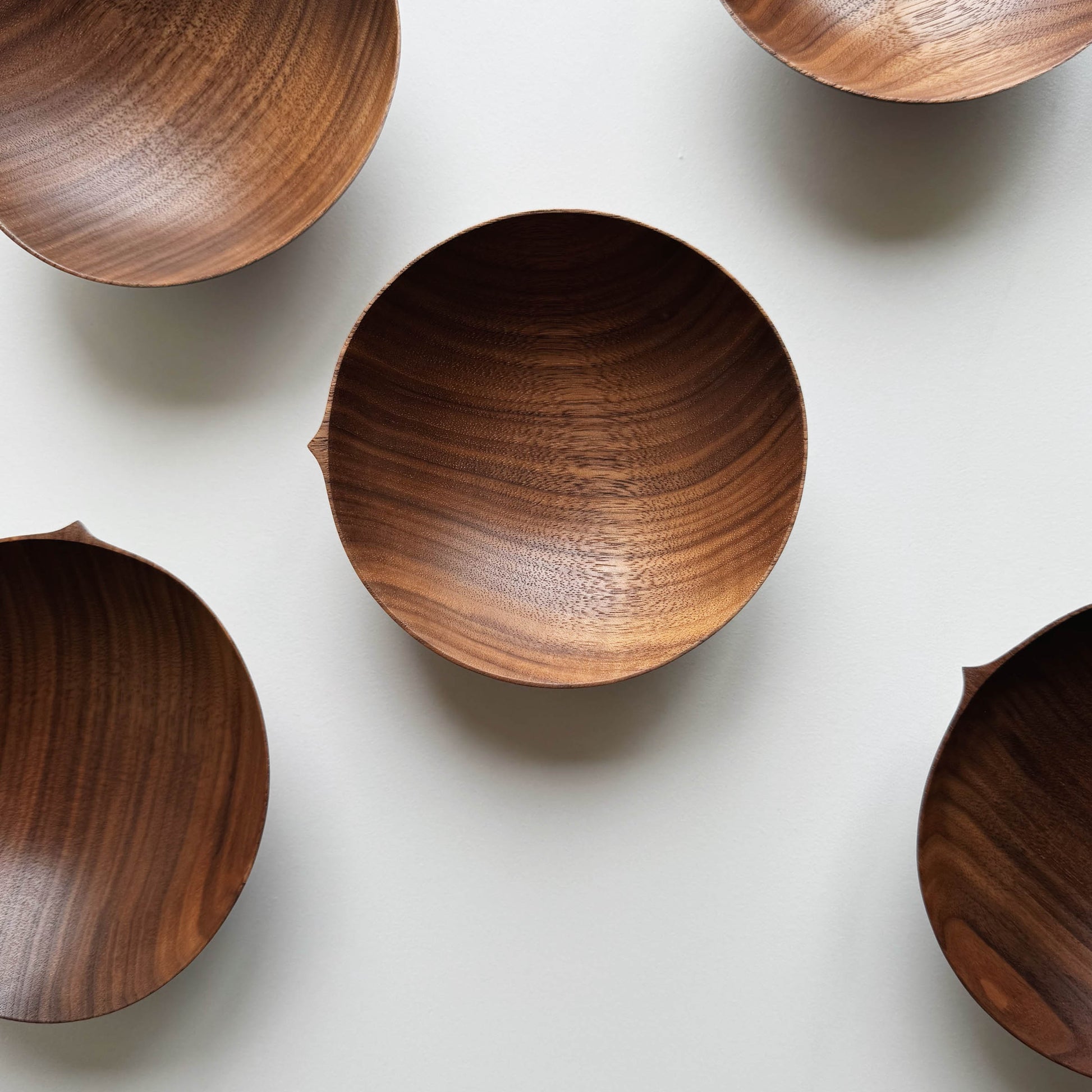 Wooden bowls in walnut on a white background